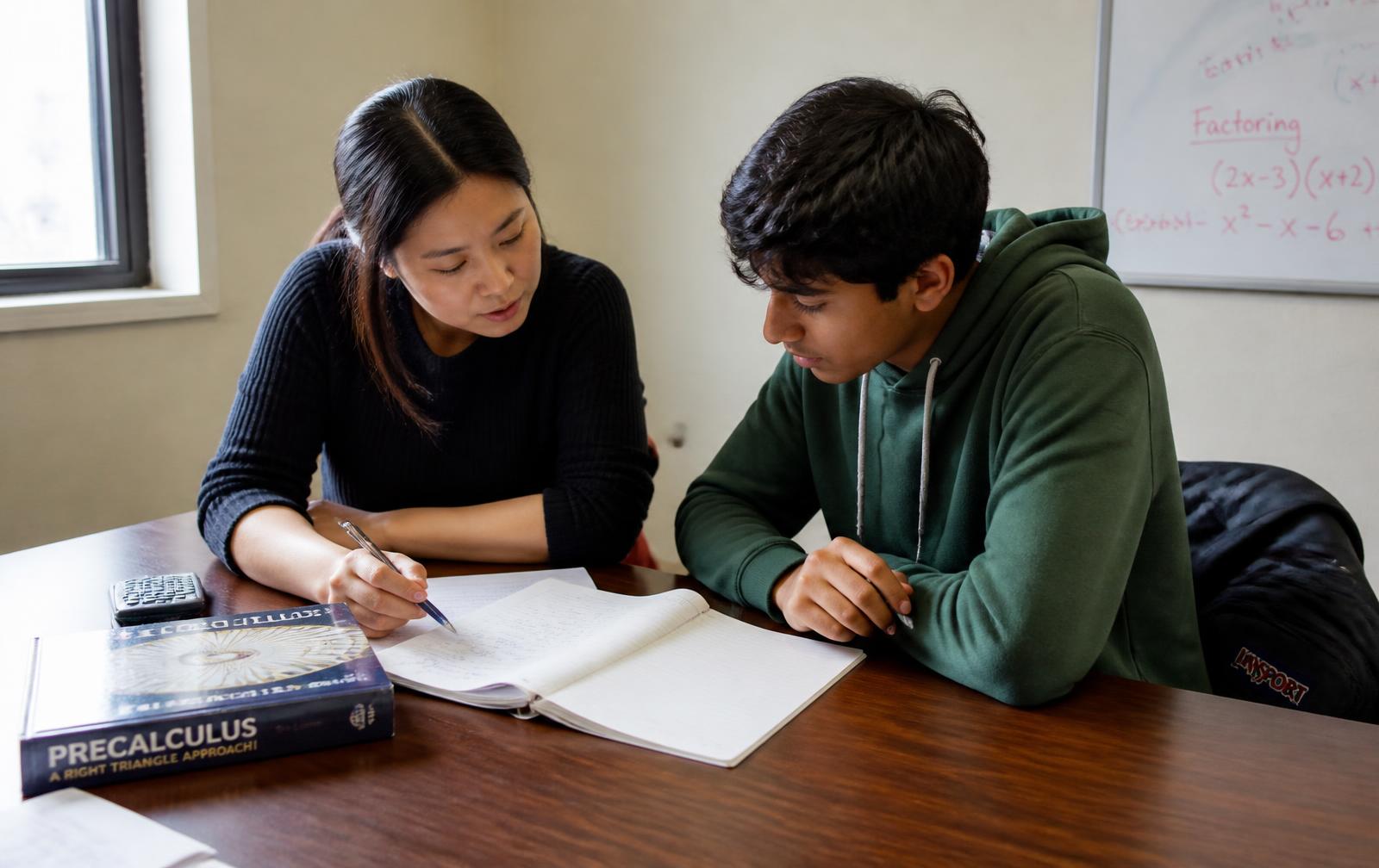 Educator working one-on-one with a high school student